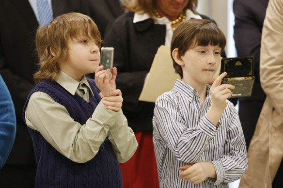 Elijah Whittle and Christian Currans, both 5th-grade students at Richardsville Elementary School (Warren County), record the speakers at the Capitol Education Center open house in Frankfort, Ky. Photo by Amy Wallot, Feb. 8, 2013