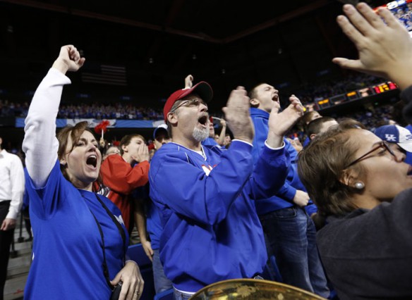 Beth Nowlin, a secretary at Madison Central High School, and her husband Phillip Nowlin cheer on the Braves against Holmes High School during the KHSAA Boys Sweet 16 quarterfinals at Rupp Arena. Photo by Amy Wallot, March 8, 2013