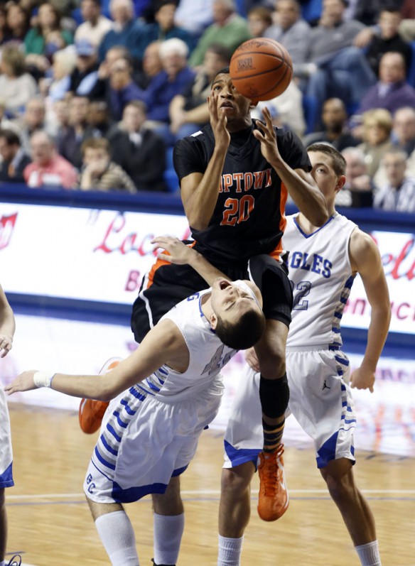 Hopkinsville High School's (Christian County) Jordan Majors fouls Graves County High School's Zach Kimbler . Photo by Amy Wallot, March 8, 2013