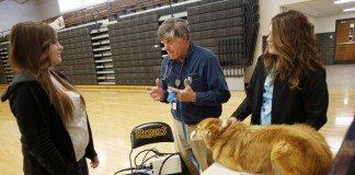 Veterinarian David Cleveland talks with sophomore Brittany Sauer about careers in animal science during Operation Preparation at Boyle County High School. Also pictured at right are veterinarian technician Chelsea Williams and Cleveland's dog Annie. Photo by Amy Wallot, March 21, 2013