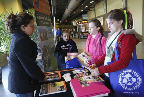 East Hardin Middle School (Hardin County) 6th-grade student Katie Estes, second from right, tells Elissa Baertschi, left, executive director of the equine scholars program at Georgetown College, about her plans to someday open a therapeutic center for horses. Photo by Amy Wallot, March 27, 2013