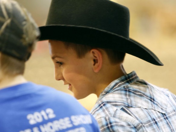 Breckenridge County Middle School 6th-grade student Dalton Taylor watches a demonstration on a variety of horse carts. Photo by Amy Wallot, March 27, 2013