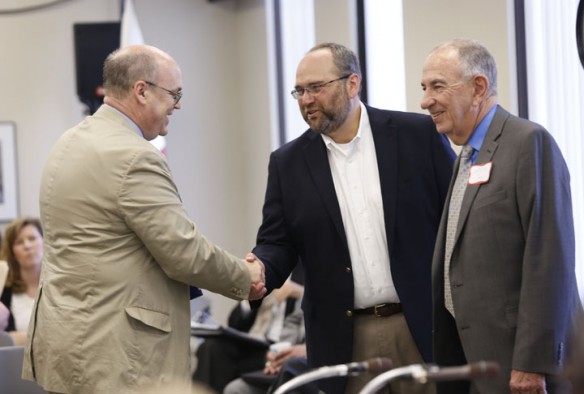 Judge Phillip Shepherd, left, shakes hands with Trevor Bonnstetter, center, and Grayson Boyd after they were sworn in as members of the Kentucky Board of Education before the board's meeting in Frankfort. Photo by Amy Wallot, April 10 , 2013
