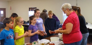 Pendleton County Extension Homemaker Rachel Conrad helps Northern Elementary School 5th-grade students make an easy fruit salad. Photo submitted