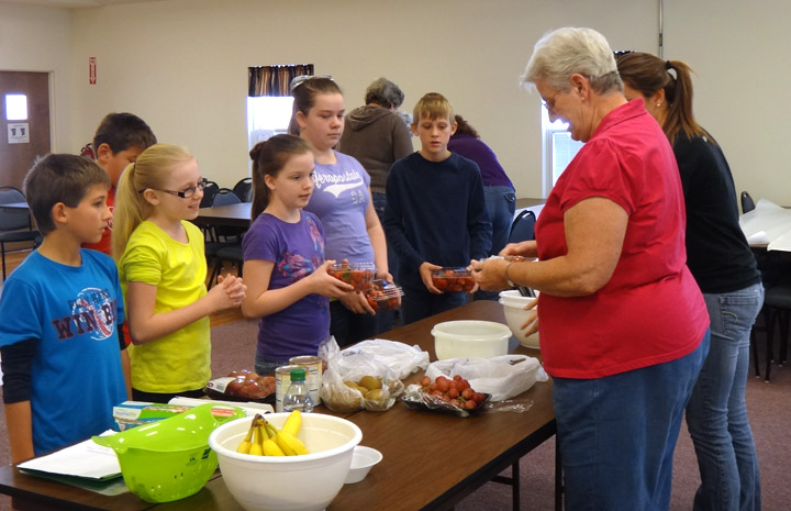 Pendleton County Extension Homemaker Rachel Conrad helps Northern Elementary School 5th-grade students make an easy fruit salad. Photo submitted