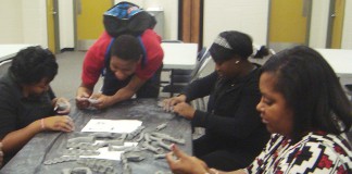 Seneca High School Principal Michelle Dillard molds clay bones with students as part of the One Million Bones project. Photo submitted