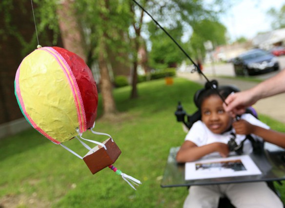 Kenly Burton flies her paper-mache hot air balloon by using a fishing pole. Photo by Amy Wallot, April 26, 2013