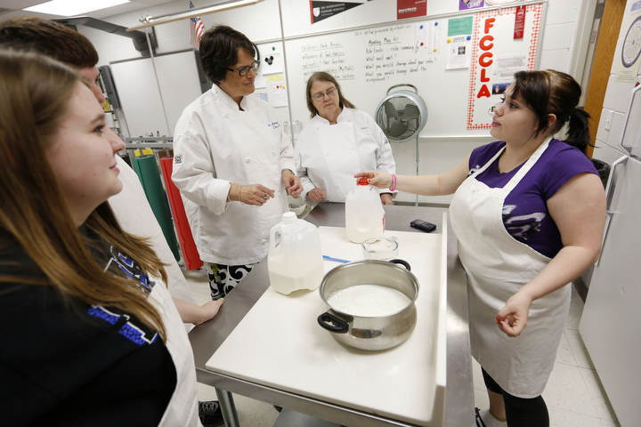 Teachers Cary York and Melanie Stamper, center, co-teach a lesson about making cheese during York’s basic foods class at East Jessamine High School (Jessamine County) Stamper is a chemistry teacher at East Jessamine High. She and York collaborate together throughout the school year. Photo by Amy Wallot, May 22, 2013