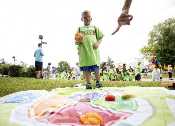 First-grade student Jayden Wall decides which food group a grapefruit belongs to while playing a nutrition game. Photo by Amy Wallot, June 5, 2013