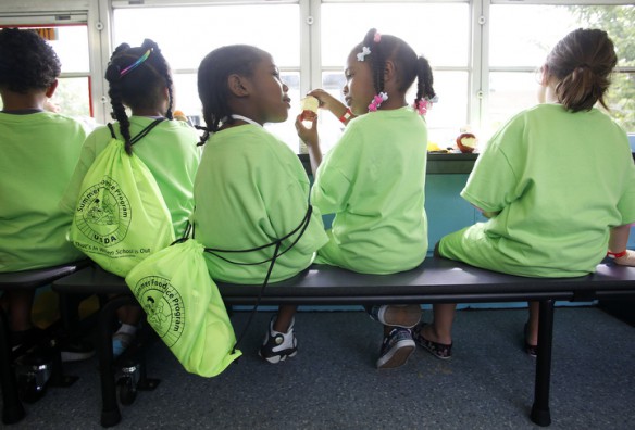 First-grade students Amir Ferguson and Inari Guy talk about the apples in their lunch. Photo by Amy Wallot, June 5, 2013