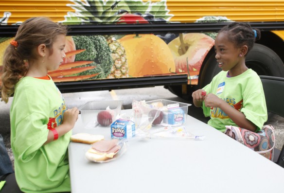 Miah Williams and Jaci Thomas have lunch just outside of the Bus Stop Café. Photo by Amy Wallot, June 5, 2013