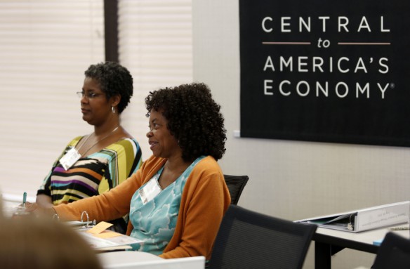 Brandeis Elementary School (Jefferson County) primary teachers Regina Puryear and Etta Ray listen to a story highlighting scarcity during the Teaching Economics through Children’s Literature Workshop. Photo by Amy Wallot, June 26, 2013