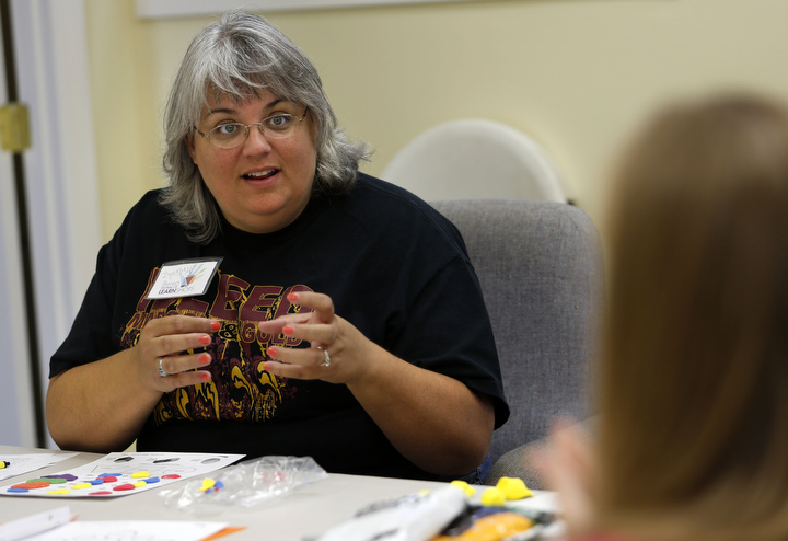 John Hardin High School (Hardin County) art teacher Brenda Harting shares teaching techniques with other art teachers during a professional learning class on color mixing lead by Kentucky artist Luann Vermillion. Photo by Amy Wallot, July 22, 2013