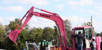 Students learn to operate a track-hoe by rolling giant dice. It was provided by the Construction Machinery Company and is pink to commemorate Breast Cancer Awareness Month. Photo by Tim Thornberry, Sept. 25, 2013
