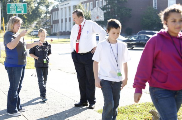 As students in Jessica Goldy Elliott's 5th-grade class walked past the Bath County Board of Education office Superintendent Harvey Tackett joined in to listen to a podcast about Christopher Columbus during a walking classroom session at Owingsville Elementary School (Bath County). Photo by Amy Wallot, Sept. 27, 2013