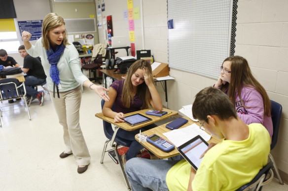 Mathematics and practical living teacher Amanda Baker discusses illegal questions to ask as an employer during a job interview with 8th-grade students Hayley Roberts, Brooke Hamilton and Cole Fitzpatrick at J.M. Stumbo Elementary School (Floyd County). Photo by Amy Wallot, Oct. 10, 2013