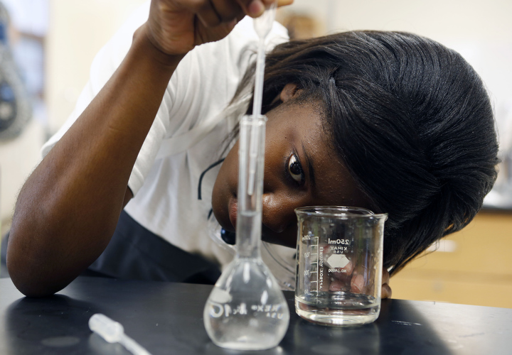 X'Zashea Mayes prepares a solution during Simone Parker's AP Chemistry class at Trigg County High School. Mayes is planning on studying medicine or chemistry at the University of Louisville. Photo by Amy Wallot, Oct. 15, 2013