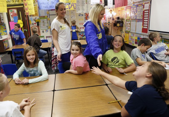 Caldwell County High School student athletes Meg Gilkey and Kaitlynn Gilkey high five students in Amy Littlejohn's 4th-grade class after mentoring in the class at Caldwell County Elementary School. Photo by Amy Wallot, Oct. 15, 2013