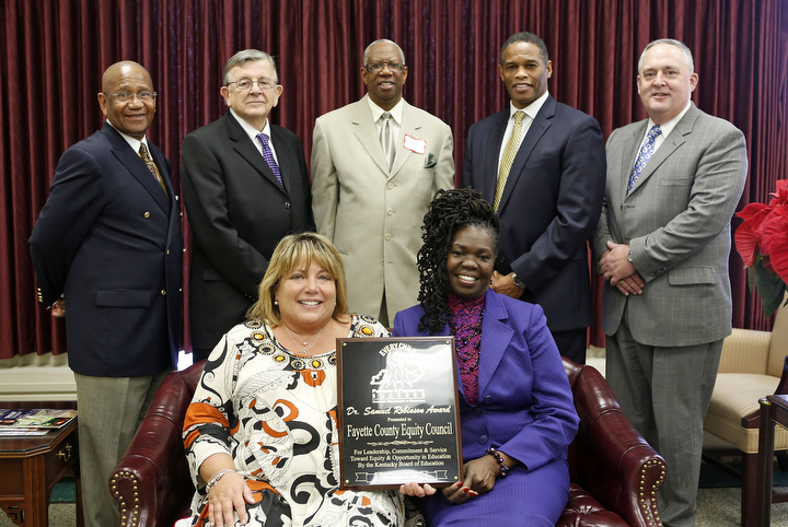 The Kentucky Board of Education presented the annual Dr. Samuel Robinson Award to the Fayette County Equity Council during the board's meeting in Frankfort. Pictured are, front row: Lisa Berman and Barbara Connor; back row: P.G. Peeples, Jack Burch, Roy Woods, Vince Mattox and Tom Shelton. Photo by Amy Wallot, Dec. 4, 2013