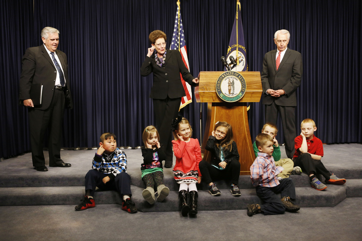 Terry Tolan, executive director of the GovernorÕs Office of Early Childhood, center, has a group of student demonstrate a sample of the kindergarten readiness screener, like identifying where your ear is located, during a press conference with Education Commissioner Terry Holliday, left, and Gov. Steve Beshear, right, at the Capitol. Photo by Amy Wallot, Jan. 30, 2013