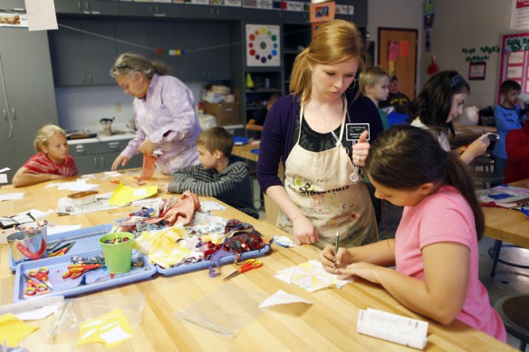 Teaching artist Dianne Simpson and art teacher Bethany Inman assist students making quilt square art at Heartland Elementary School (Hardin County). Simpson works to create projects that integrate core content from arts and humanities like process and design principles with history, culture and mathematics (2-D and 3-D concepts and pattern discovery). Photo by Amy Wallot, Oct. 24, 2013