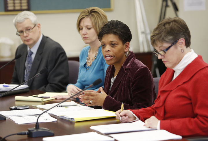 Assistant General Counsel David Wickersham, acting director of the Division of Next Generation Professionals Amanda Ellis, Associate Commissioner Felicia Cumings Smith and staff assistant Robin Chandler discuss changes in the evaluation guidelines of the Professional Growth and Effectiveness System during the Kentucky Board of Education meeting. Photo by Amy Wallot, Feb. 5, 2013