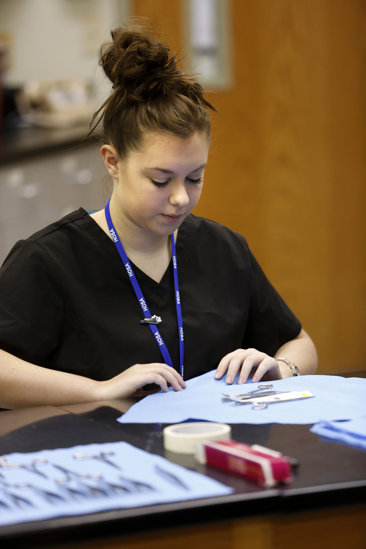 Marshall County Technical Center student Kaitlynn Cooper wraps items for autoclave while competing in medical assisting during the HOSA state conference in Louisville, Ky. Photo by Amy Wallot, March 14, 2014