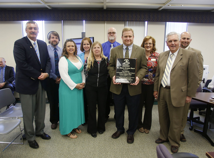 Kentucky Board of Education Chairman Roger Marcum, left, and Commissioner of Education Terry Holliday, right, present Tim Schlosser and the Franklin-Simpson High School Student Support Team with the Dr. Johnnie Grissom Award in Frankfort, Ky. Photo by Amy Wallot, April 9, 2014