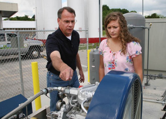 David Hargis, left, Somerset Fuel Center Manager, explains natural gas fueling processes to Maci New, the first student to sign up for Pulaski County Area Technology Center's natural gas pipeline technician program. Photo by Tim Thornberry, May 23, 2013