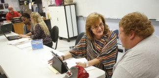 Shelia Baugh, director of specialized instructional programs for Simpson County Schools, reviews junior Garrett Cothern's recent assignment grades with him during a Student Support Team meeting at Franklin-Simpson High School. Photo by Amy Wallot, May 15, 2014