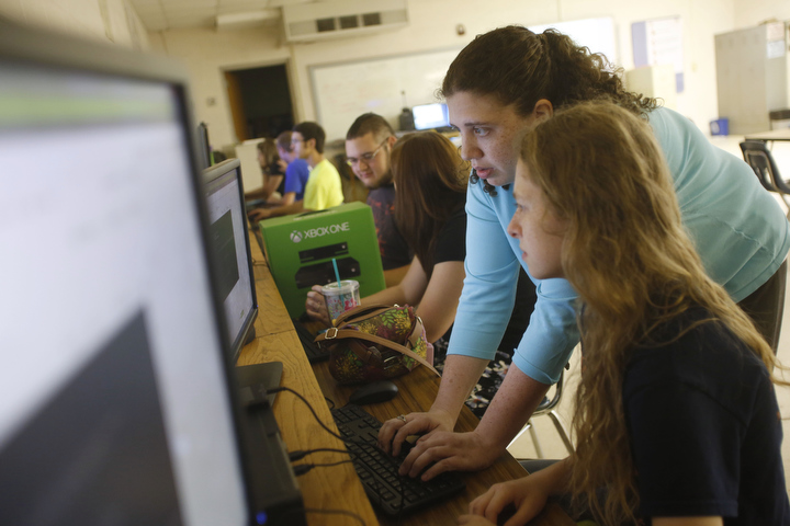Joy Neace helps junior Krystal Spencer create a cipher web page during her Intro to Computer Science class at Lee County High School. The class is part of the TEALS program and students learn from instructors off site using LYNC. Photo by Amy Wallot, May 28, 2014