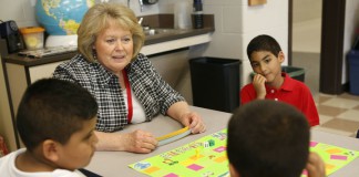 ESL teacher Betty Snyder plays a skills game with 1st-grade students Samir Salazae, Abdullah Bahanin and Yassen Mohamed at Glendover Elementary School (Fayette County). Samir speaks Spanish and Abdullah and Yassen speak Arabic. Photo by Amy Wallot, May 30, 2014