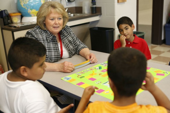 ESL teacher Betty Snyder plays a skills game with 1st-grade students Samir Salazae, Abdullah Bahanin and Yassen Mohamed at Glendover Elementary School (Fayette County). Samir speaks Spanish and Abdullah and Yassen speak Arabic. Photo by Amy Wallot, May 30, 2014