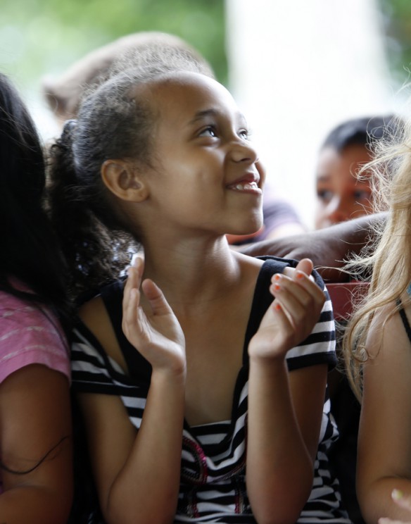 Hannah Mabson, a 2nd-grade student at Veterans Park Elementary School (Fayette County) applauds First Lady Jane Beshear during the press conference. Photo by Amy Wallot, June 11, 2014