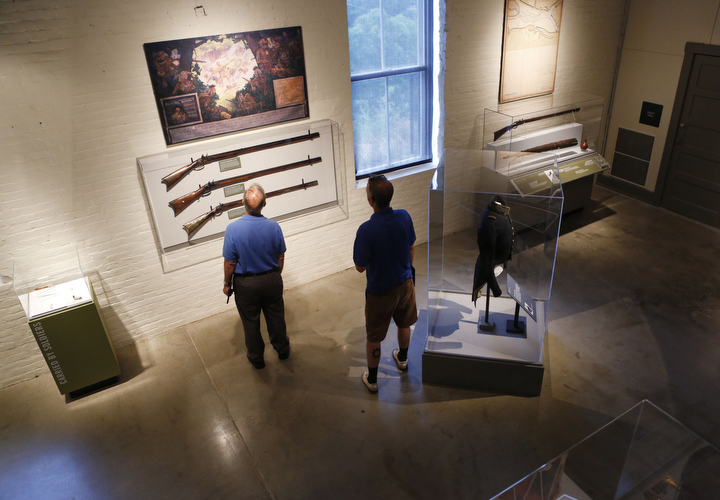 DuPont Manual High School (Jefferson County) teacher James Garrett and Henry Clay High School (Fayette County) teacher Jonathan McClintock examine Kentucky rifles from the late 1700s and early 1800s at the Kentucky Military History Museum. Photo by Amy Wallot, June 23, 2014