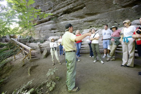 Archaeologist Randy Boedy tells how the shelter provided by the Natural Arch may have been used by past generations during Project Archaeology. Photo by Amy Wallot, July 9, 2014