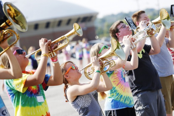 Sophomore Christa Hall, center, and the horn section practice under the hot sun. Photo by Amy Wallot, July 29, 2014