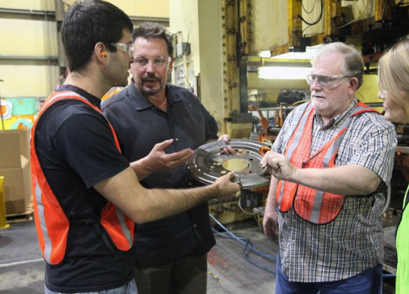 Shawnee High School (Jefferson County) teachers Adrien Armandariz, left, and Jim Kidwell, right, talked with Nth Works plant engineer Paul Meshke. Teachers visited the precision metal forming business in an effort to better understand the connection between the classroom and the workplace. Photo by Tim Thornberry, July 16, 2014