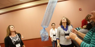 Melisa Fuhrmeister, a school health coordinator in Tennessee, Beverly Marcum, a family resource center coordinator in Owen County and Laura Shultz, a a 21st Century Community Learning Center director in Cloverport Independent, see how high an inflated diaper genie bag will bounce during the the 21st CCLC multi-state conference. Photo by Amy Wallot, Sept. 24, 2014