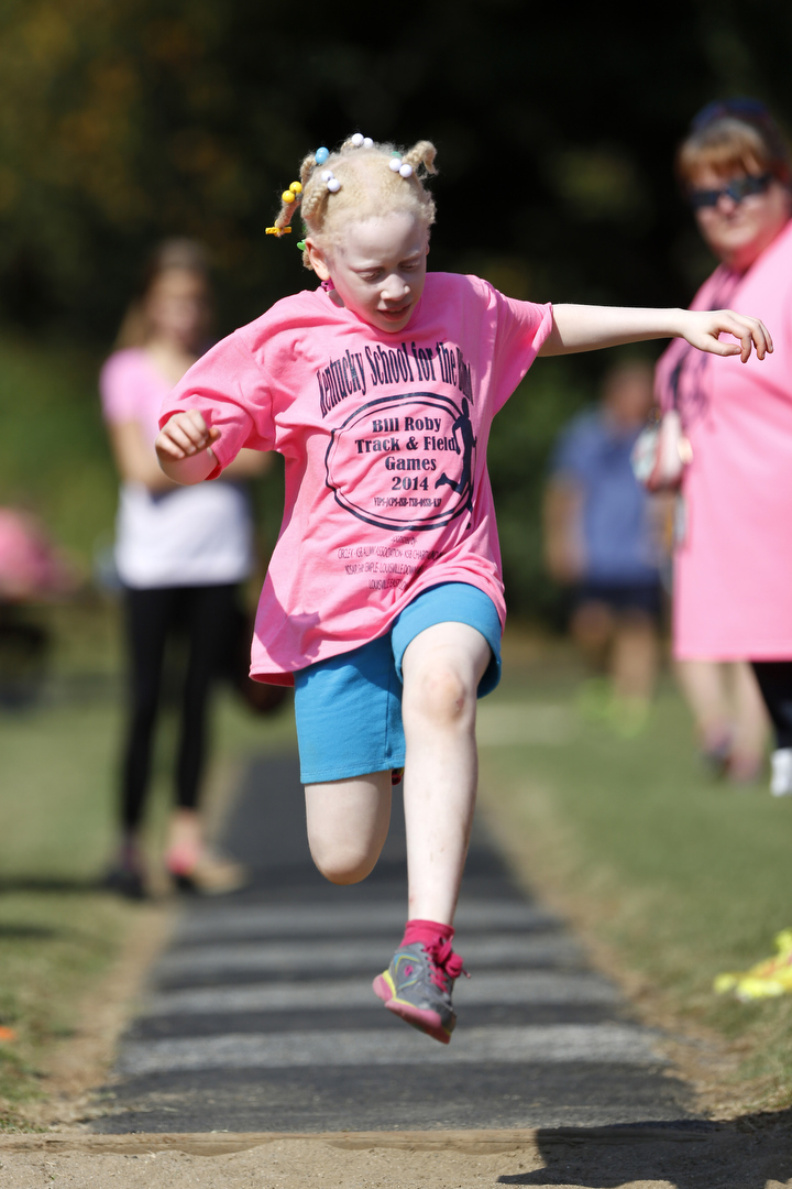 Third-grade student Naomi Williams competes in the running long jump during the the Kentucky School for the Blind's 36th Annual Bill Roby Track and Field Games for children ages 3-14 who are blind and visually impaired. She is a student at Heartland Elementary School in Hardin County. Photo by Amy Wallot, Sept. 30, 2014