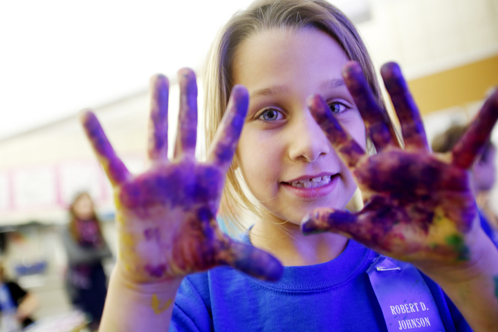 Second-grade student Ava Houze displays her paint covered hands during Nikki Evertt's art class at Johnson Elementary School (Ft. Thomas Independent). Photo by Amy Wallot, Oct. 21, 2014