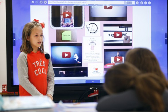 Using a large touch-screen TV, 3rd-grade student Karah Lafferty gives a presentation about being proactive, one of The Seven Habits of Happy Kids, in Lisa Salyer's class at Highland Elementary School (Johnson County). Photo by Amy Wallot, Oct. 21, 2014