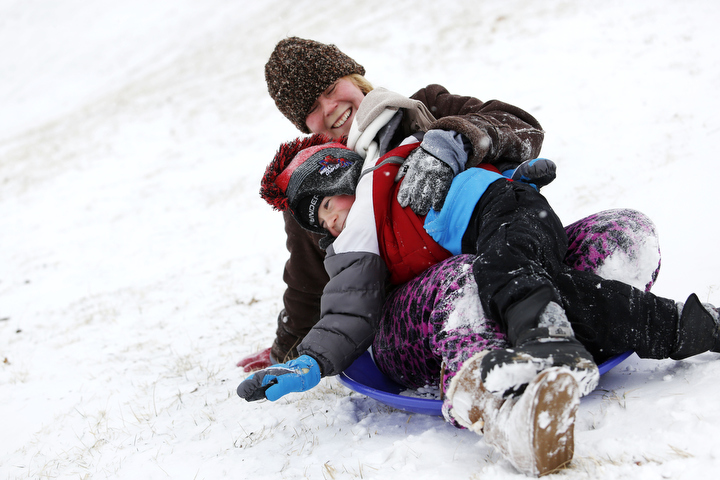 Crystal Barker and her son, preschool student Voin Barker sled down the hill together at Highland Christian Church during a snow day in Franklin County. Photo by Amy Wallot, Jan. 21, 2013