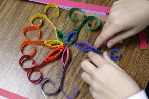 A student makes a brightly colored snowflake shape during a quilling project at Kit Carson Elementary School (Madison County). Photo by Amy Wallot, Dec. 9, 2014