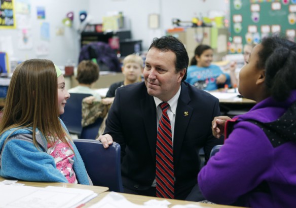 Third-grade students Brooke King and Aniyah Brooks Richardson tell Simpson County Schools Superintendent James Flynn about the Mexican jumping bean activity they did while studying life cycles in April Marlin's call at Simpson Elementary School. Photo by Amy Wallot, Dec. 4, 2014