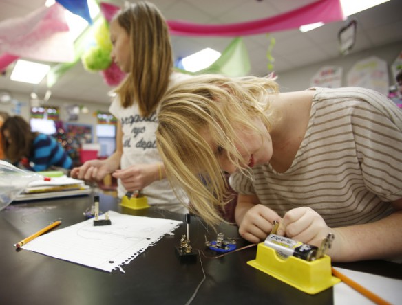 Fourth-grade students Jaysa Shelton and Abby Griner create a parallel circuit during Traci Goss' class at South Livingston Elementary School (Livingston County). Photo by Amy Wallot, Dec. 11, 2014