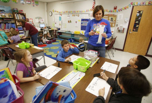 Emily Yates teaches nouns and verbs to a small group of 1st-grade students at South Livingston Elementary School (Livingston County). Photo by Amy Wallot, Dec. 11, 2014