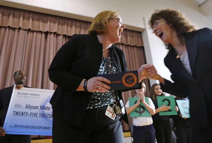 Allyson Vitato, principal at Breckinridge-Franklin Elementary School (Jefferson County), celebrates being awarded the Milken Family Foundation National Educator Award during a surprise assembly at her school. At right is Milken Education Awards senior vice president Jane Foley. Photo by Amy Wallot, Jan. 15,2015