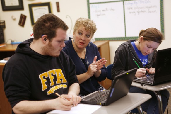Lee Alan Roher works with juniors Jeffery Carter and Brianna Jones on adding and subtracting complex numbers at the Kentucky School for the Deaf. Photo by Amy Wallot, Jan. 15, 2015