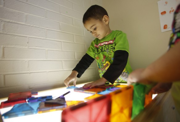 Markell Wilson plays with colored blocks on a light table during preschool class at Morganfield Elementary School (Union County). Photo by Amy Wallot, Jan. 28, 2015
